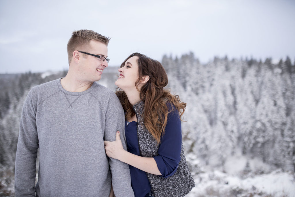 man and woman posing together during outdoor snowy photos talking about how to grow instagram following