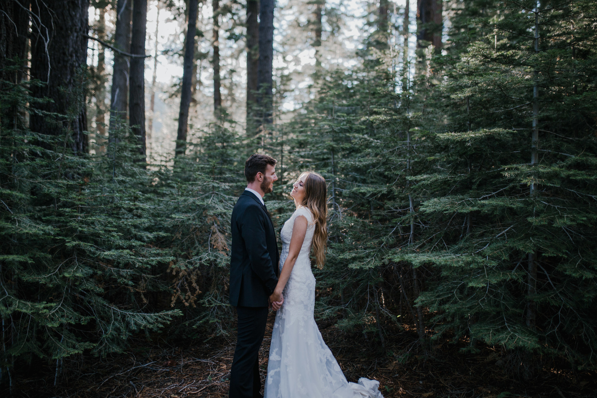 man and woman standing in forest taking bridals in Knoxville Tennessee