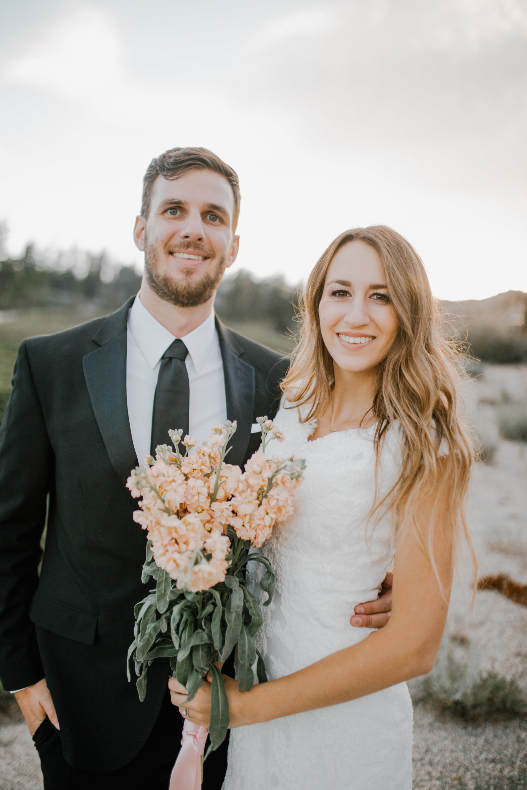 Sacramento wedding photographer captures a bride and groom standing in the mountains