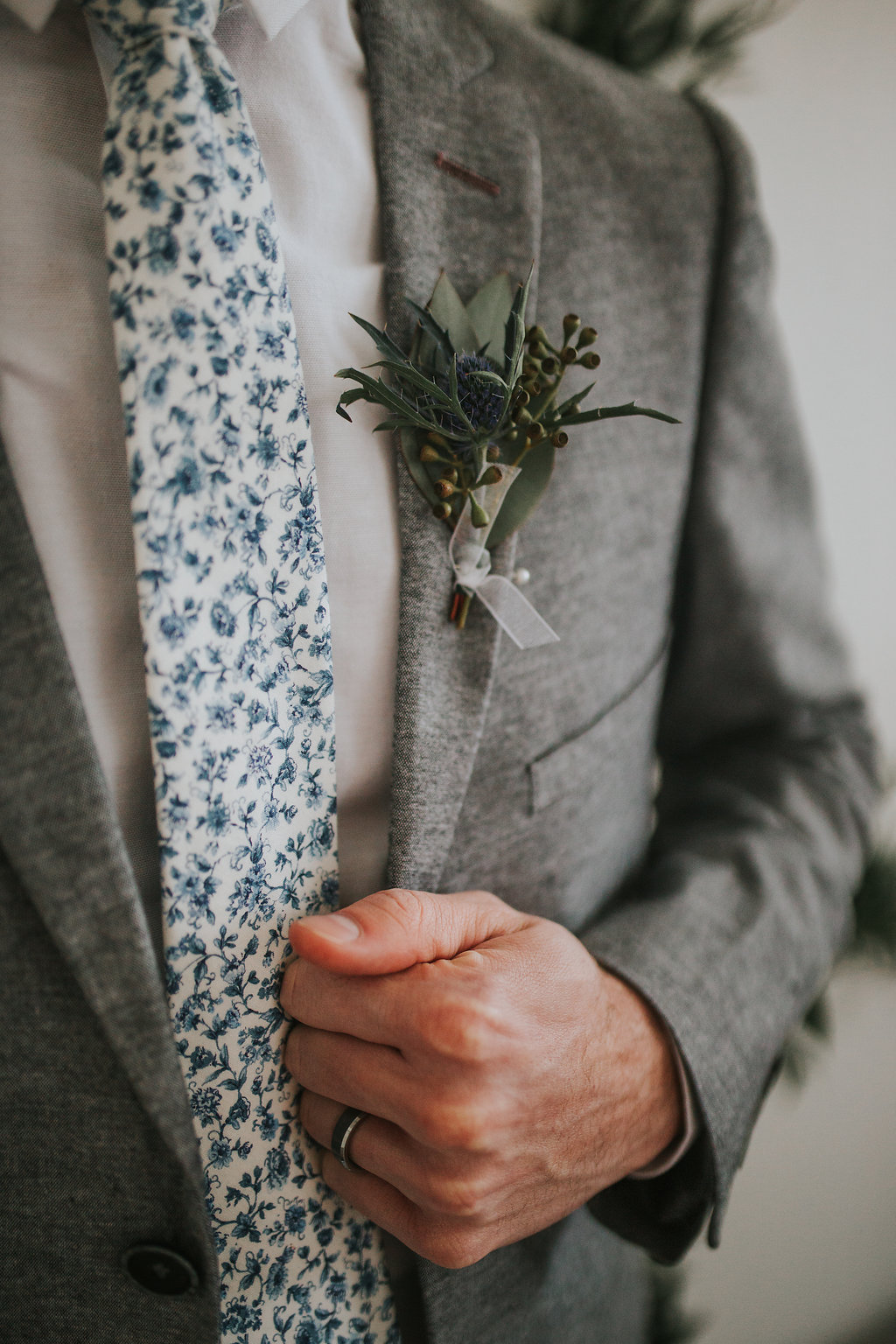 detail shot of groom holding his suit jacket