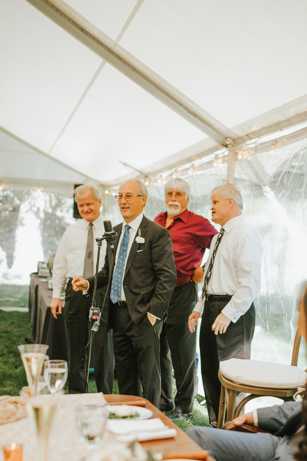 men standing in a white canopy for a Tennessee summer wedding