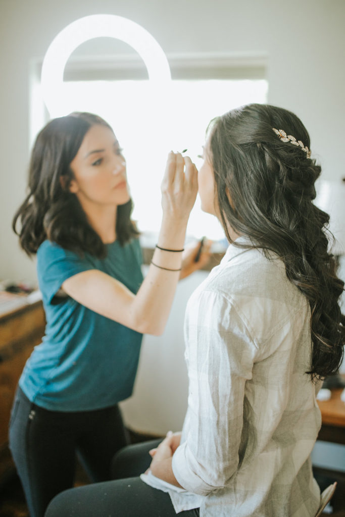 bride getting makeup done by Morgan Fay