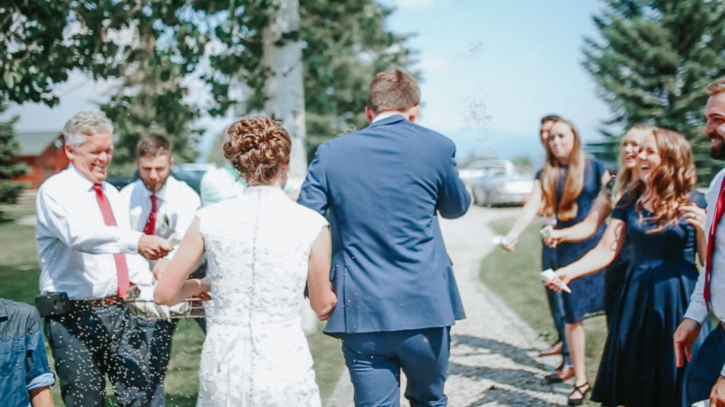 sending off the bride and groom during a bright blue day