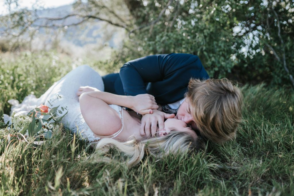 bride-and-groom-laying-in-grass-kissing-chattanooga-wedding