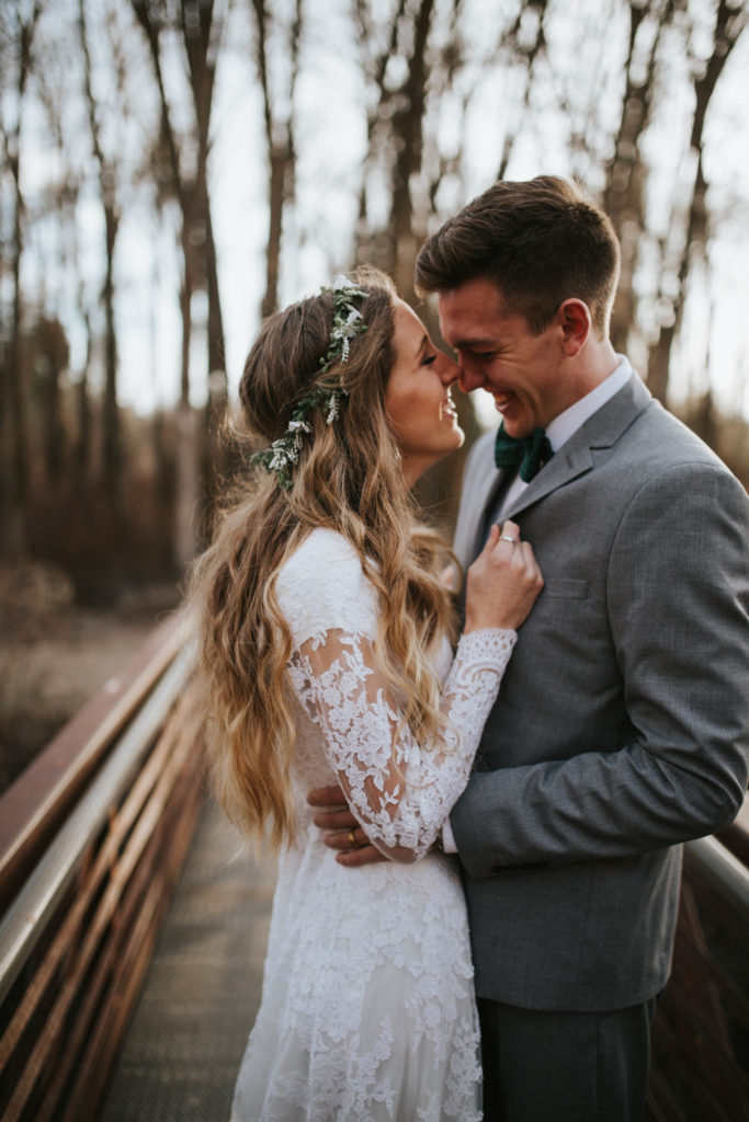 bride and groom kissing on bridge in smoky monutain national park