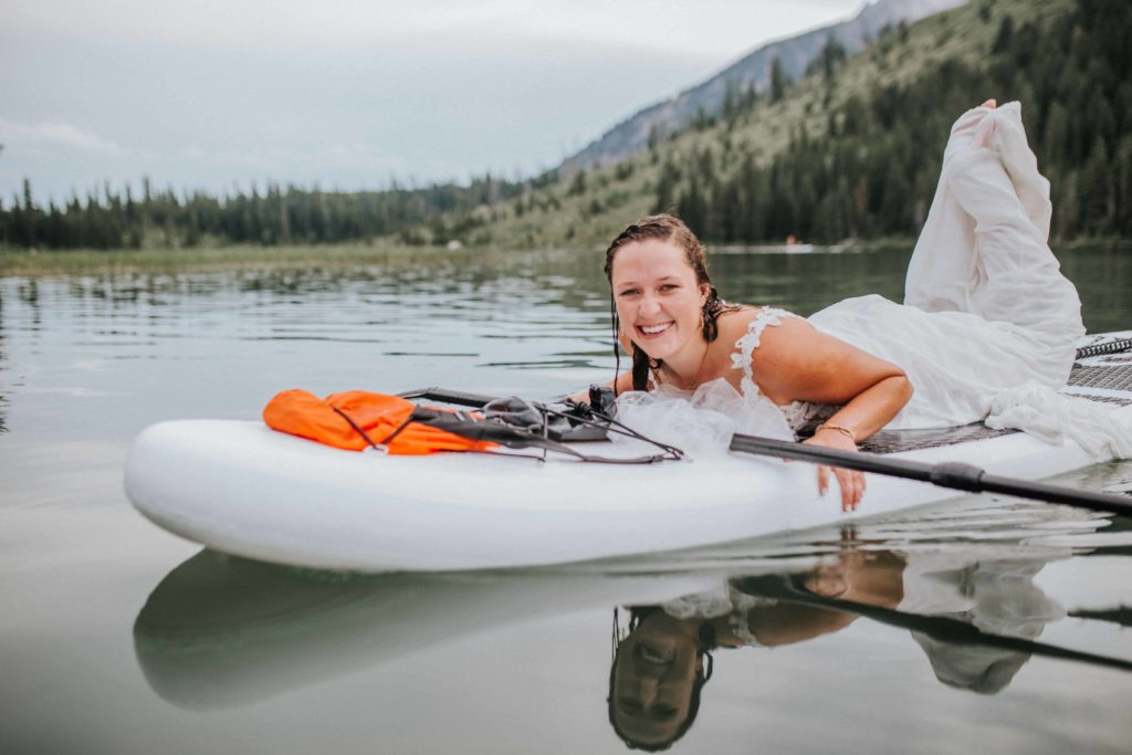 adventure session with a gorgeous bride in her gown soaked with water on a paddle board