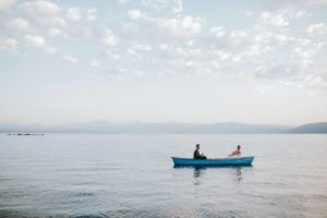bride and groom paddle across the water at this chattanooga wedding venue