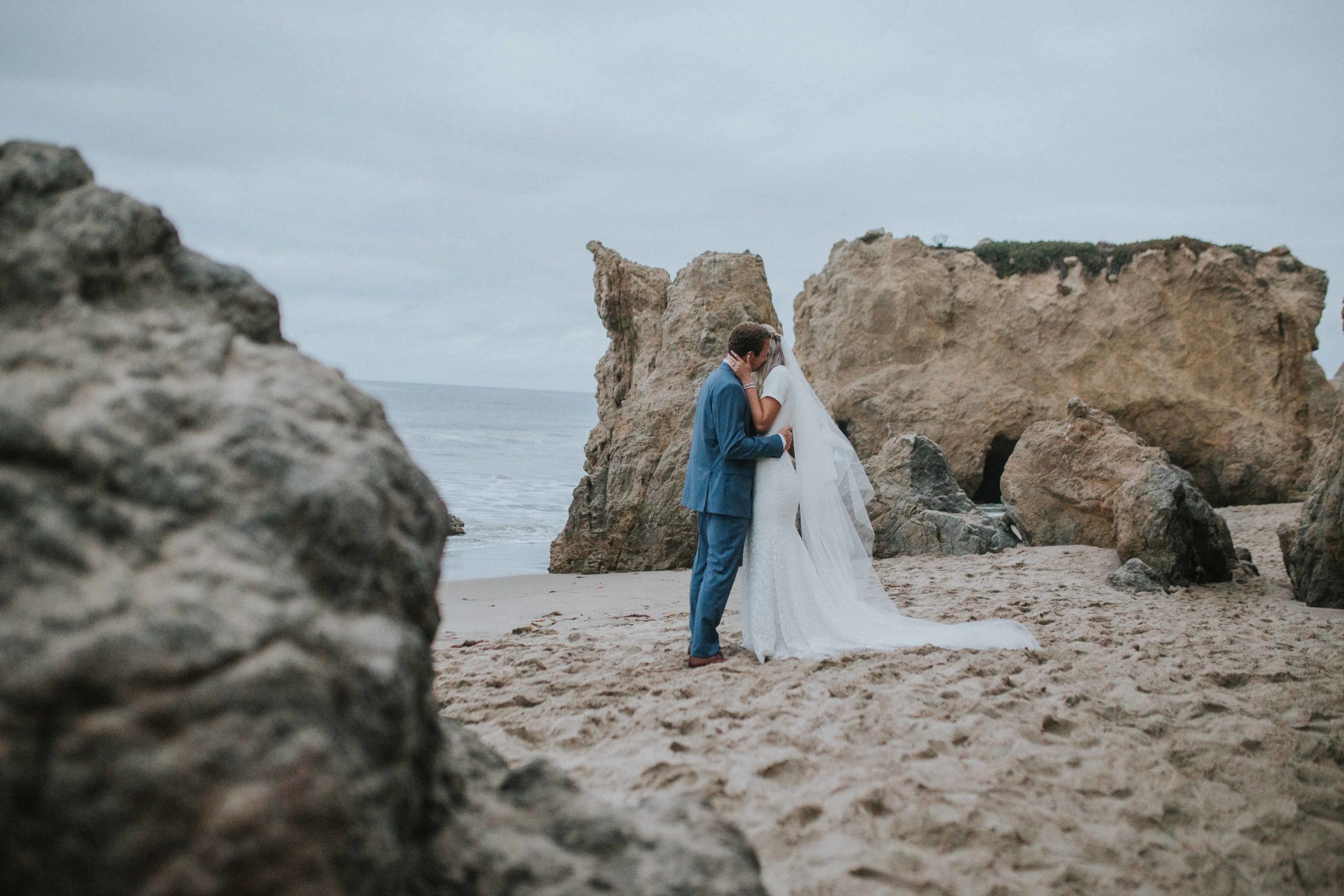 bride and groom hugging on beach in outer banks after adventure elopement and how to grow instagram following