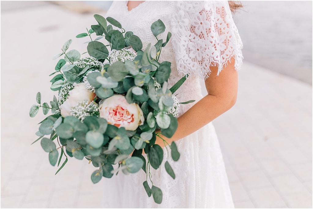 detail shot of a brides vintage elegant lace dress and wedding bouquet