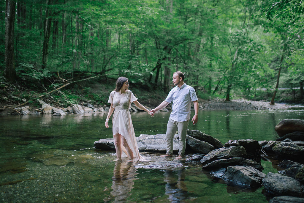 smoky mountains engagements cades cove couple walking in water