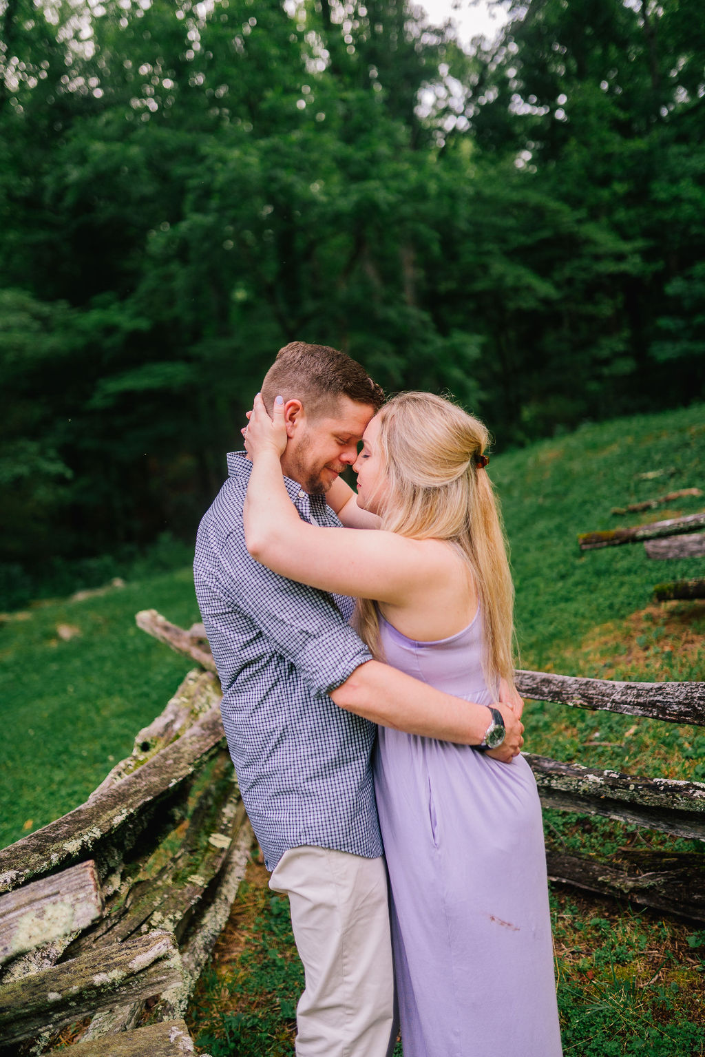 engaged couple hugging and smiling during engagement session after perfect proposal planning