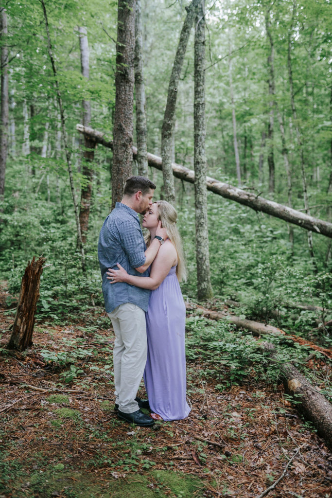 Cade's Cove engagement session boy kissing forehead in the middle of the forest