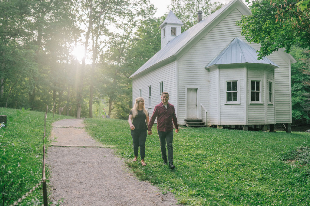 Cade's Cove engagement session walking next to baptist chapel