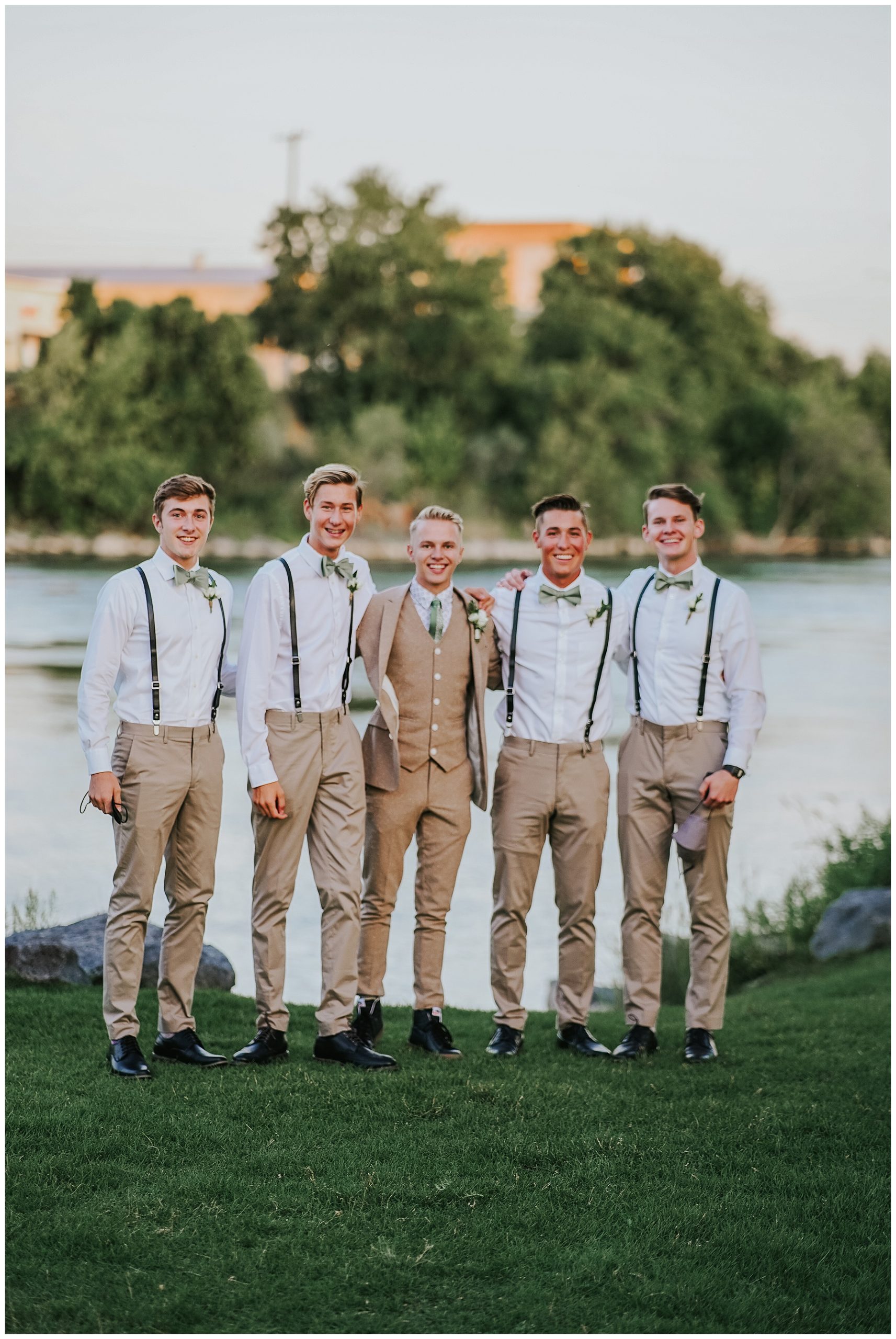 groom and his groomsmen standing together in tan suits at a river bed in Tennessee