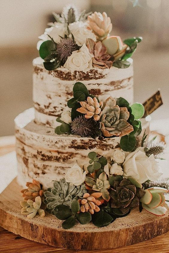 boho themed natural rustic cake with floral and succulents featured on cake