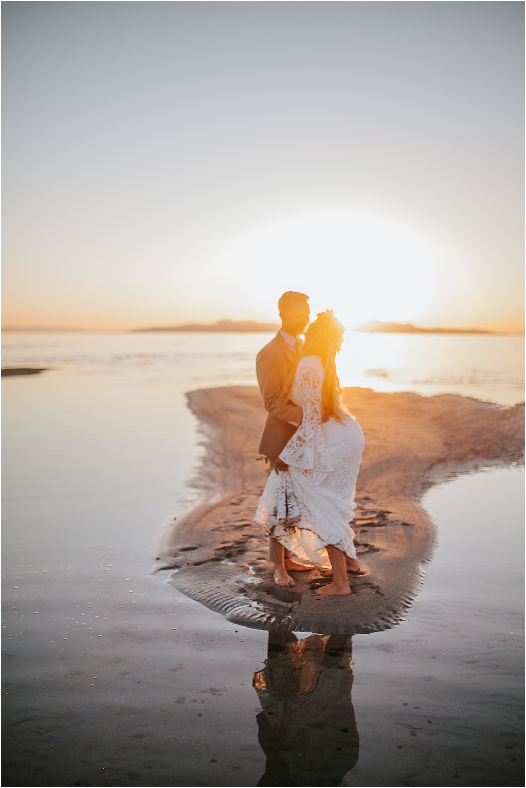 Sacramento wedding photographer captures bride and groom dancing as the sun sets behind them as they are on the sand