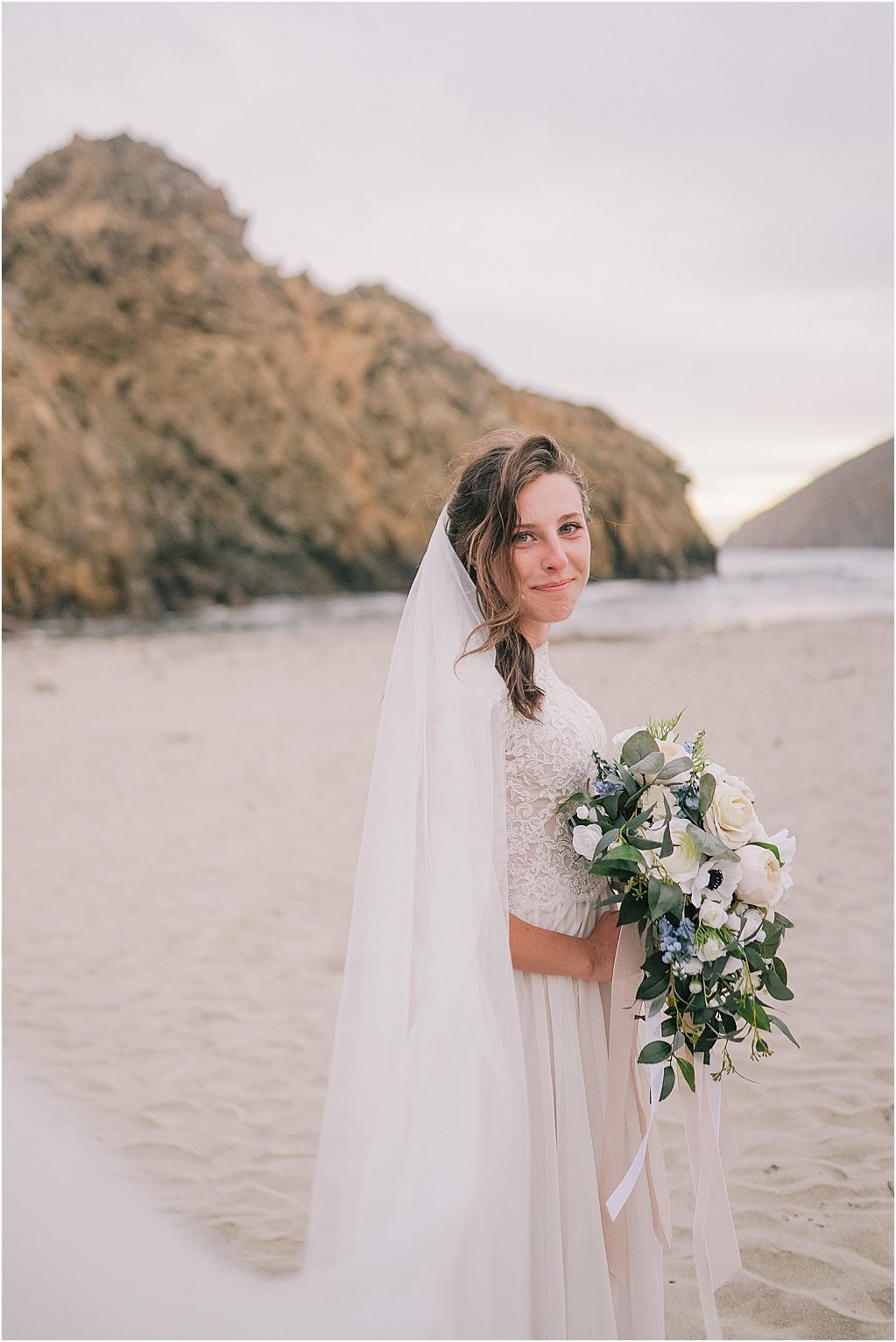Outer banks big sur elopement photographer bridal portrait with elegant lace dress greenery bouquet