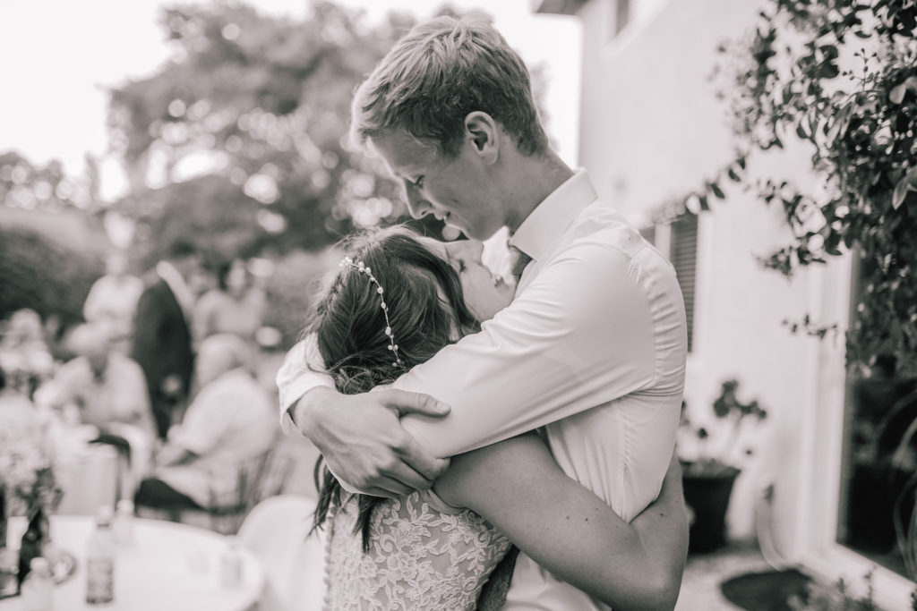 black and white photo wedding couple hugging each other and smiling