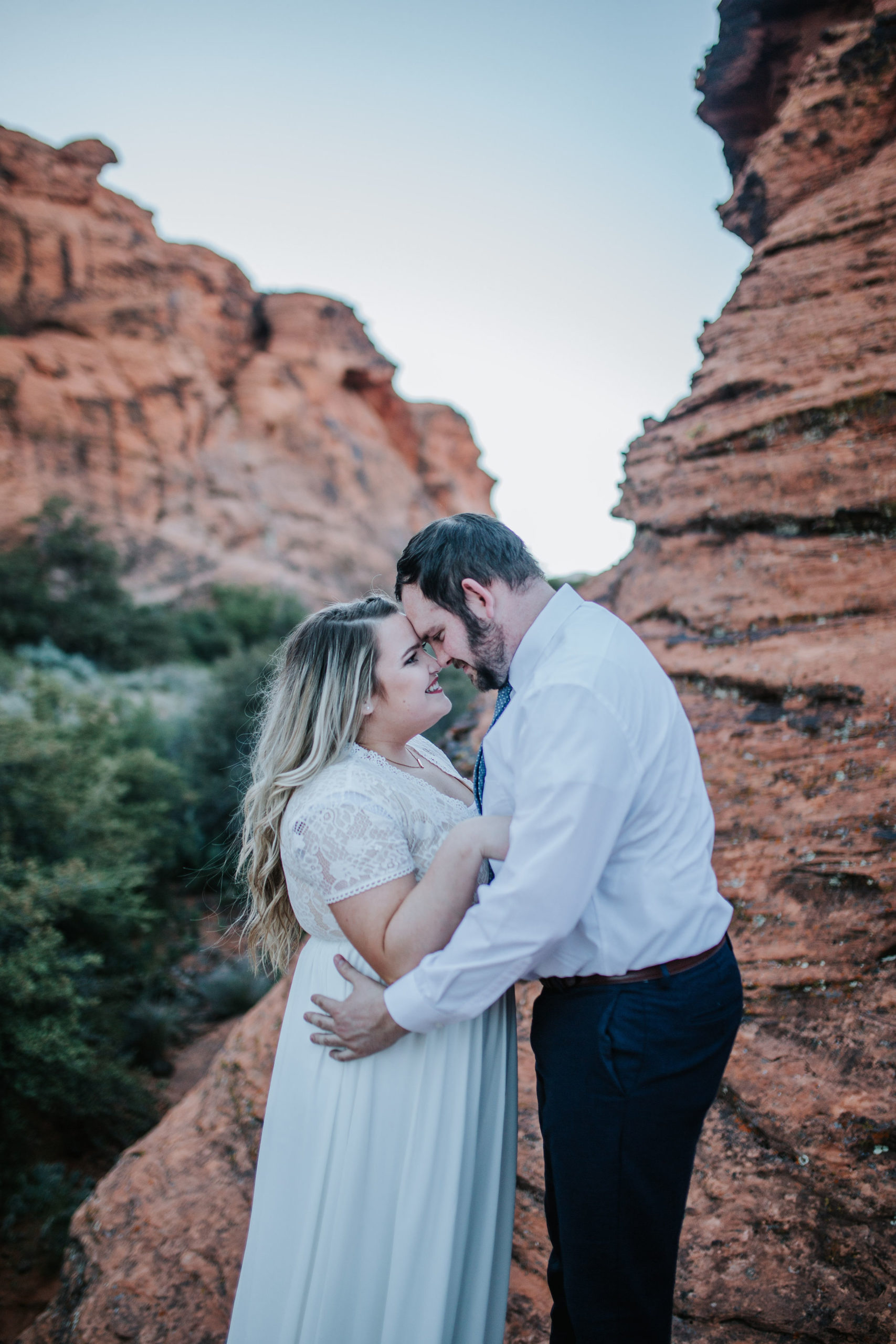 bride and groom on an adventure session for bridal in red rocks holding each other and looking into each there eyes