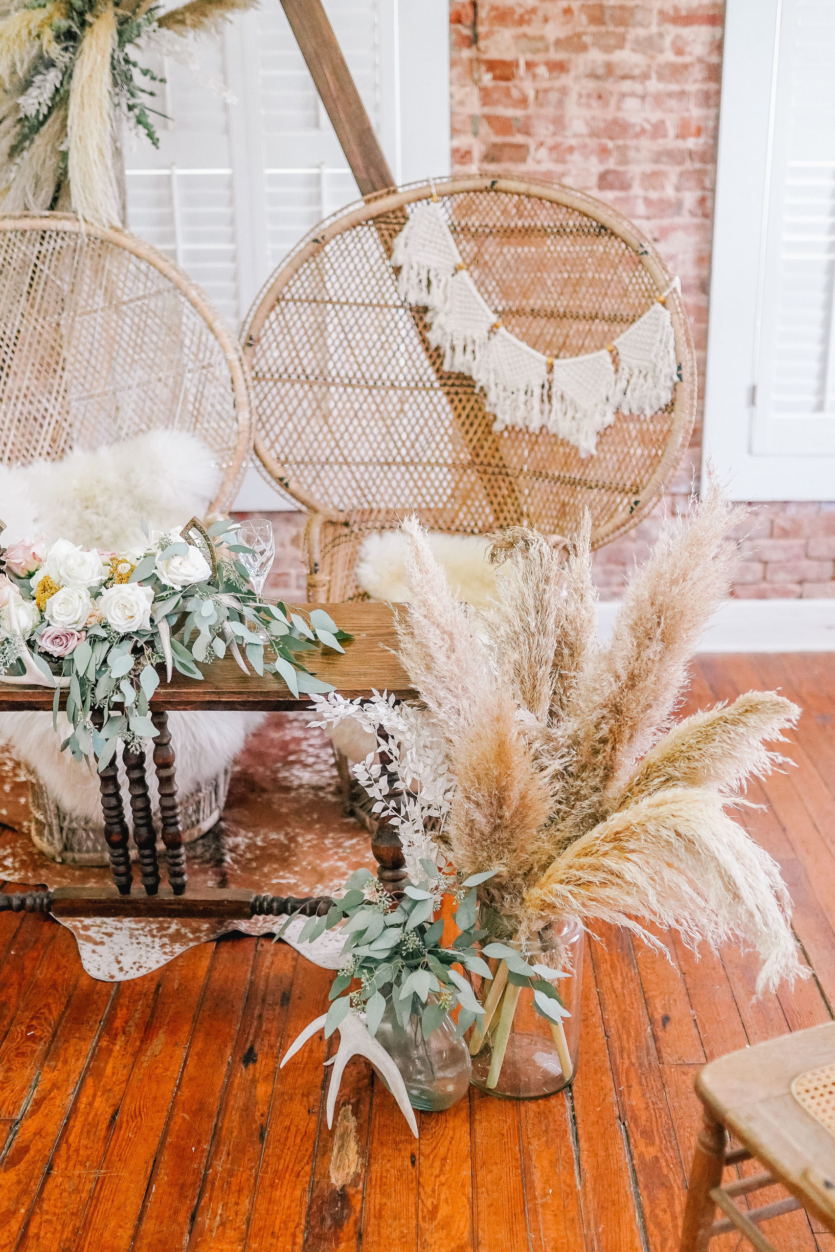 rustic and boho budget friendly wedding decor with wicker chairs and macrame garland