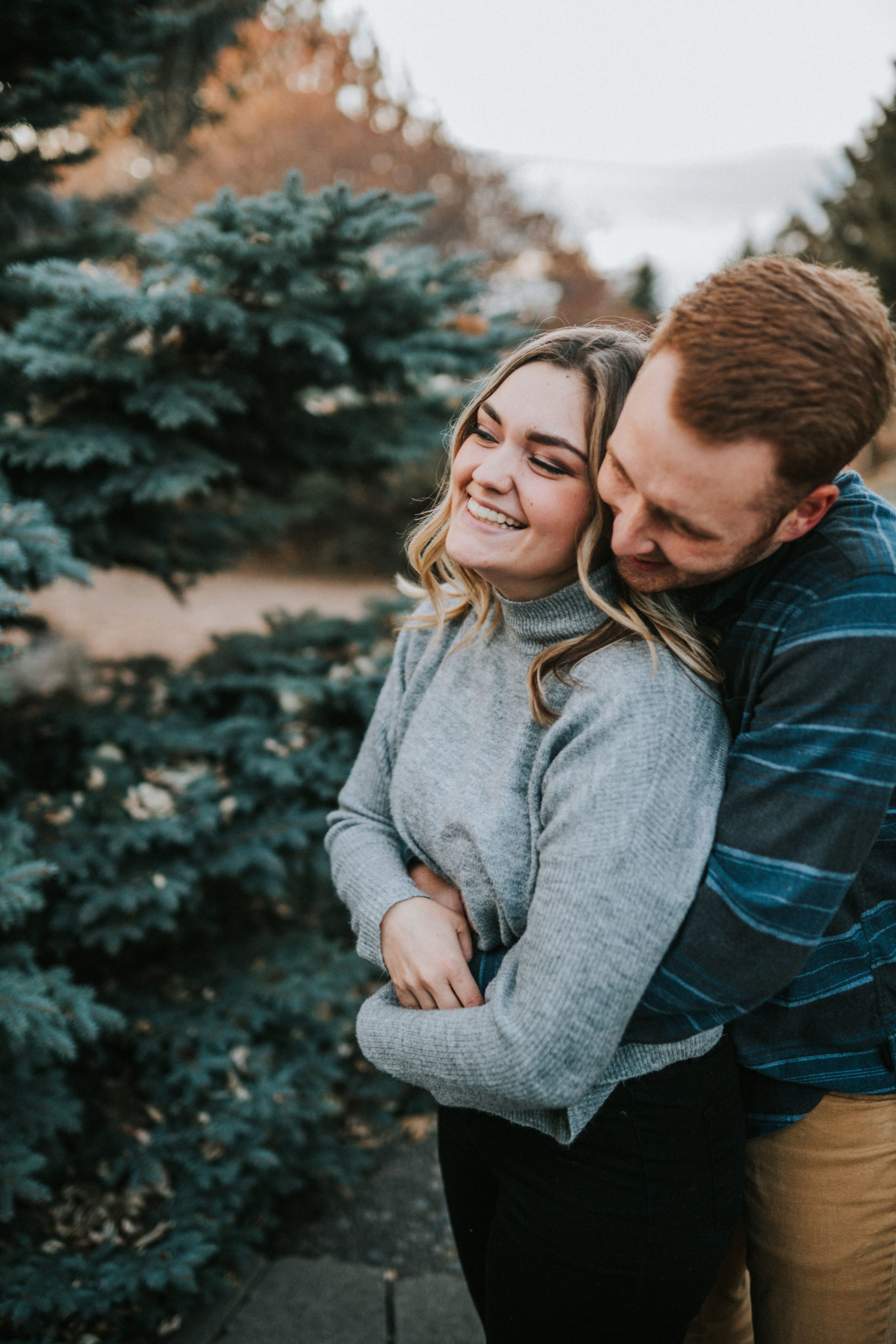 man and woman hugging and smiling during engagement session in tennessee