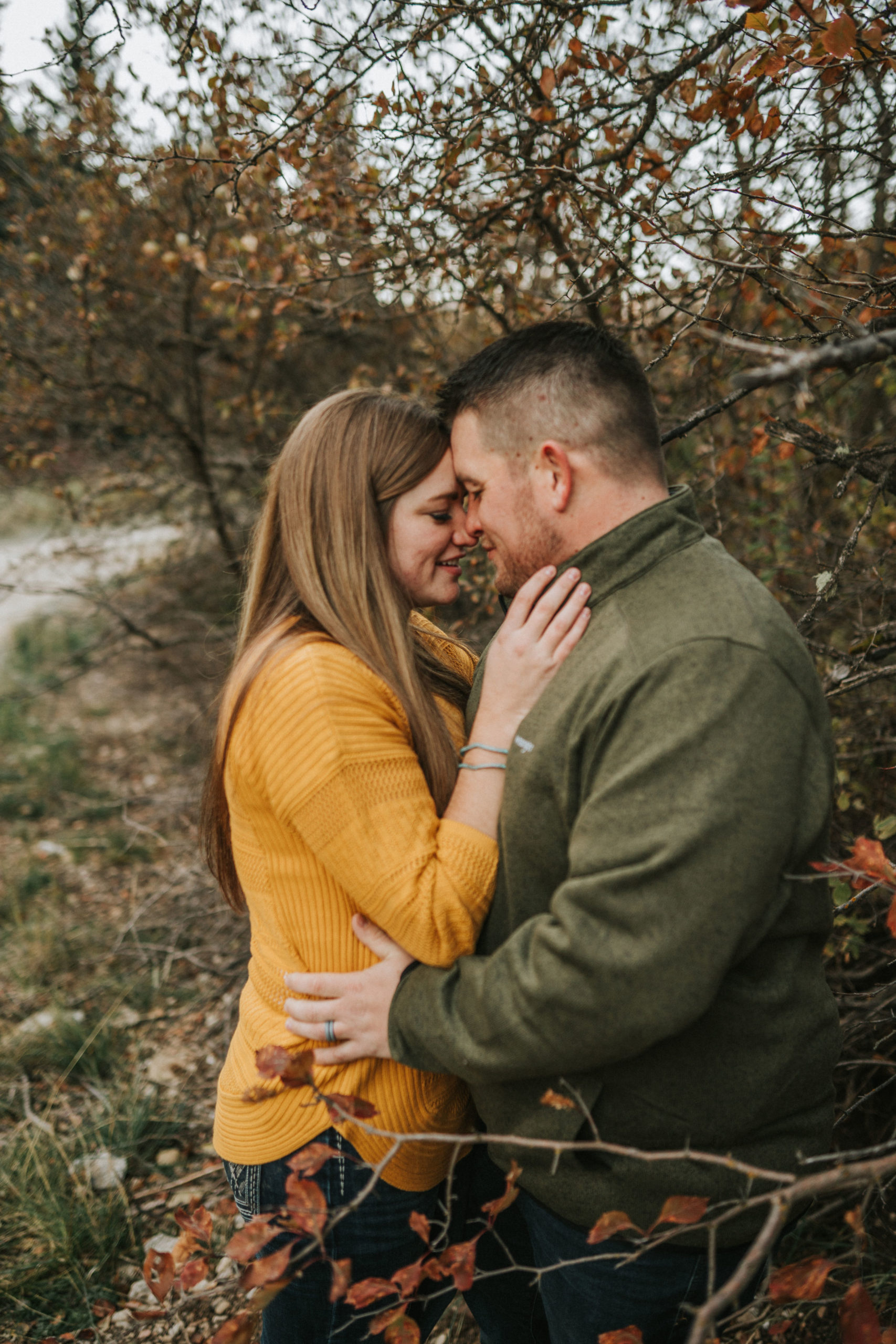 man and woman hugging and posing during fall engagement session in knoxville tennessee