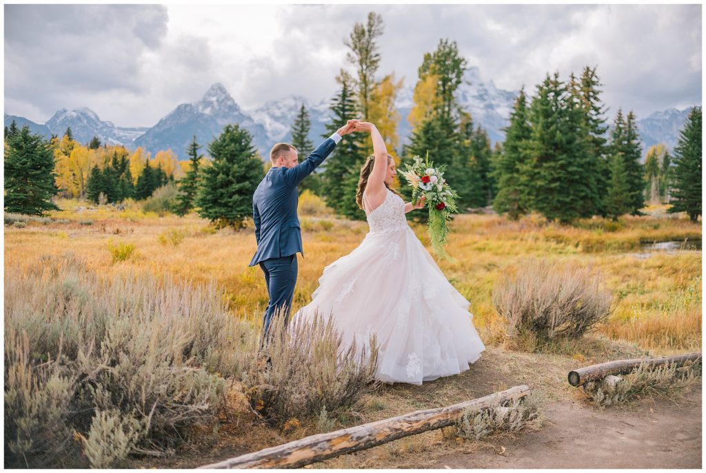 man spinning woman around during outdoor elopement in Grand Tetons