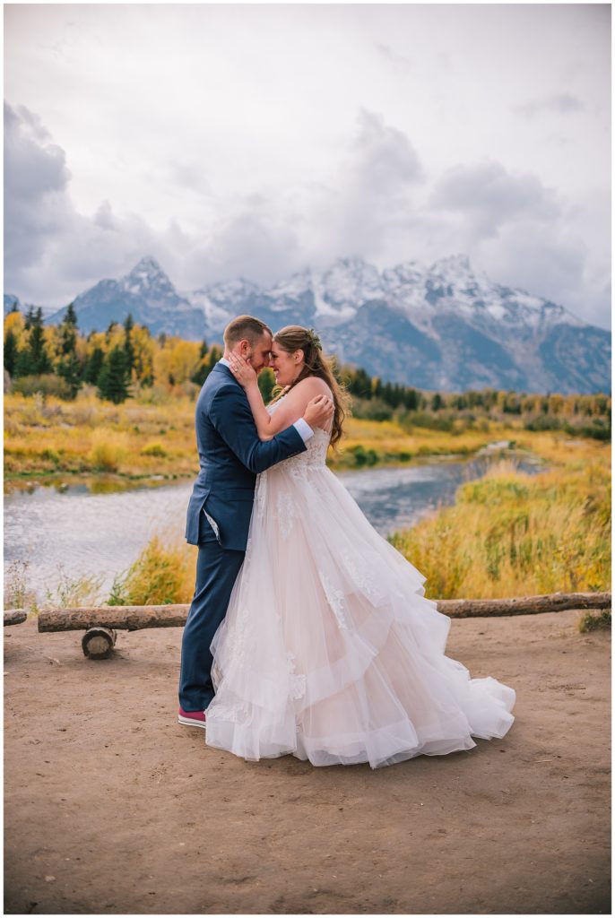 bride and groom hugging in front of Grand tetons during bridal session