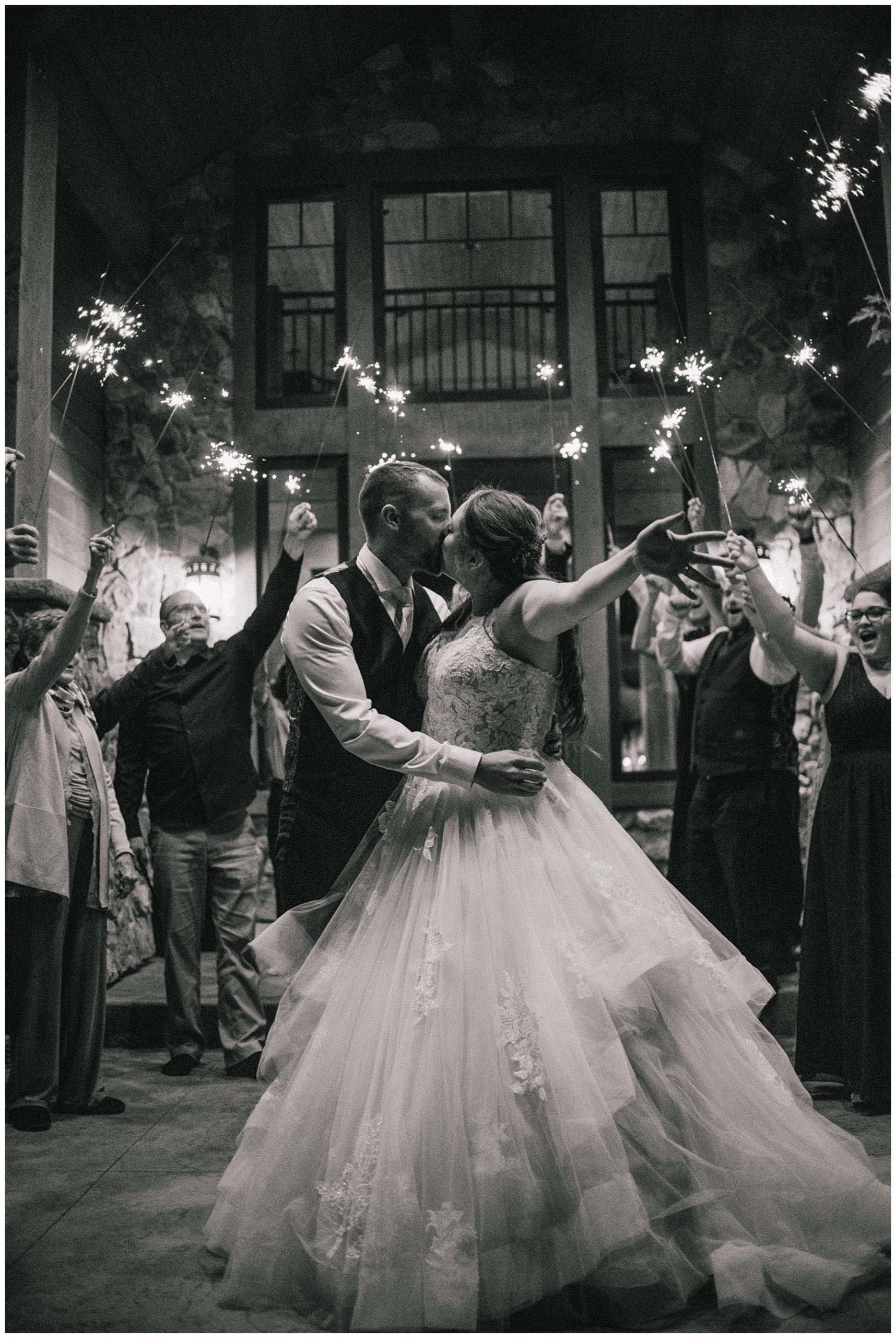 bride and groom kissing during sparkler exit after grand tetons elopement
