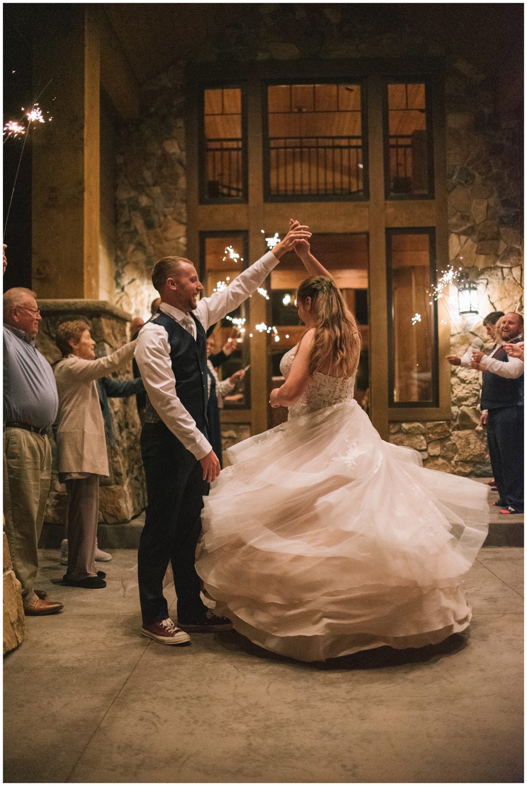 groom spinning bride during sparkler exit at elopement