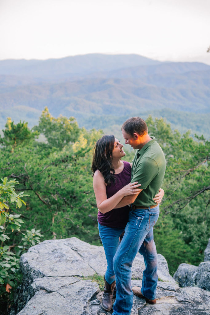 Southern couple in the Smokies embracing each other on top of a mountain