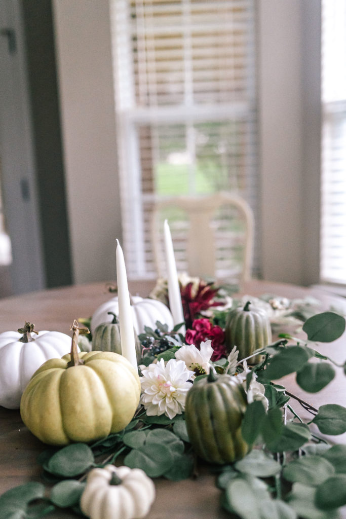 southern kitchen table decorated for fall with neutral pumpkins and eucalyptus leaves
