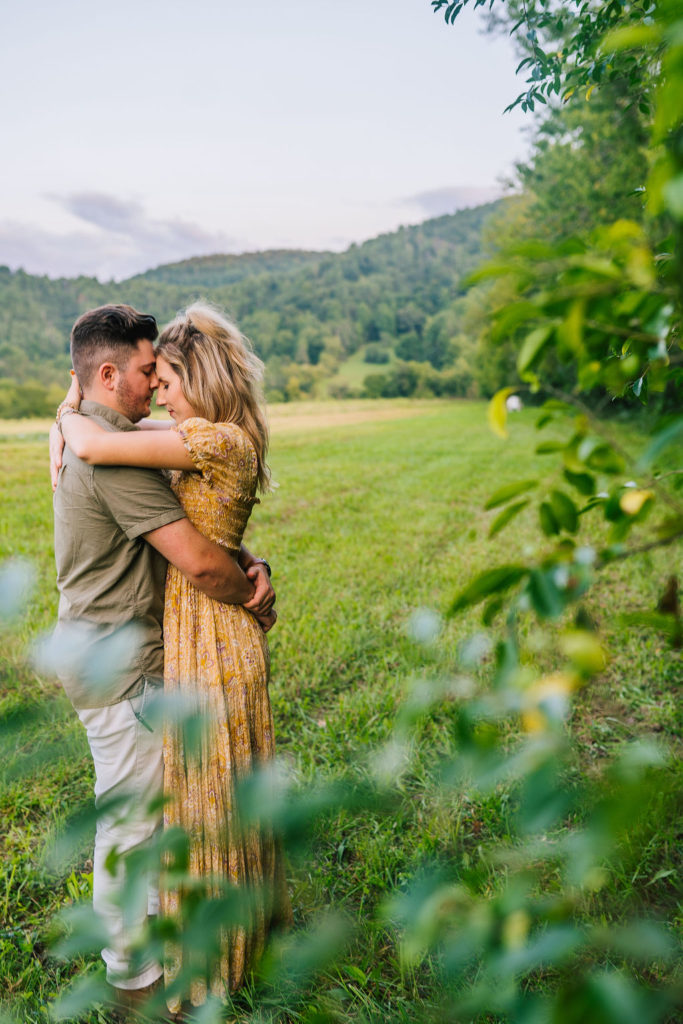 couple hugging in tennessee forest engagement session