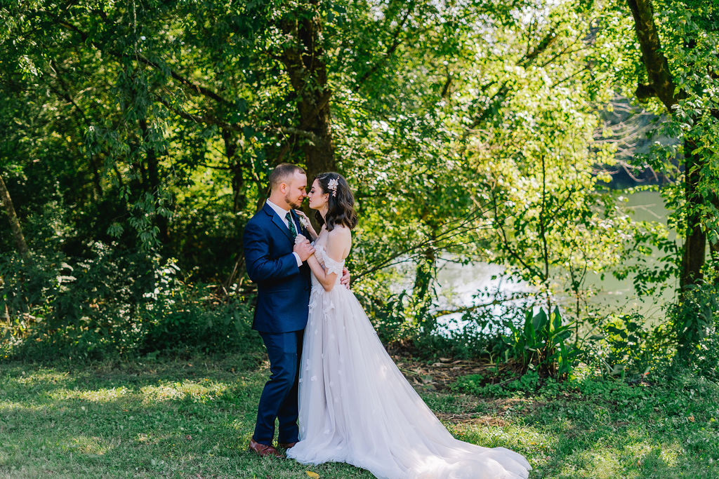 bride and groom hugging and dancing in knoxville forest after celebrating budget friendly wedding