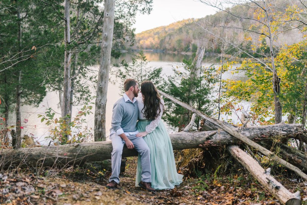 Engagement session at Norris Lake. The woman is wearing a soft tulle and lace dress 