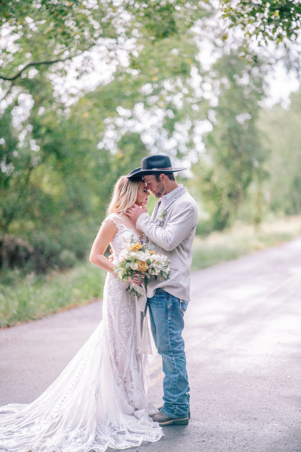 bride and groom touching foreheads and posing during outdoor bridals in louisiana wedding