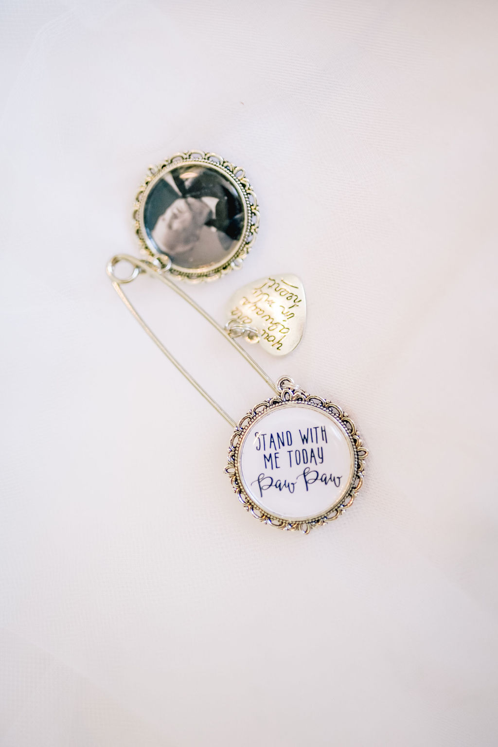 sentimental piece for bride to wear hidden on her wedding day with a pin attached to a pendant with a picture of her grandfather