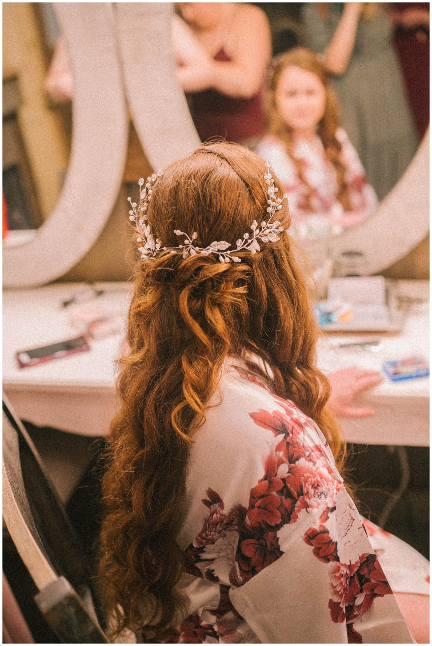 bride looking into mirror on wedding day before walking down the aisle
