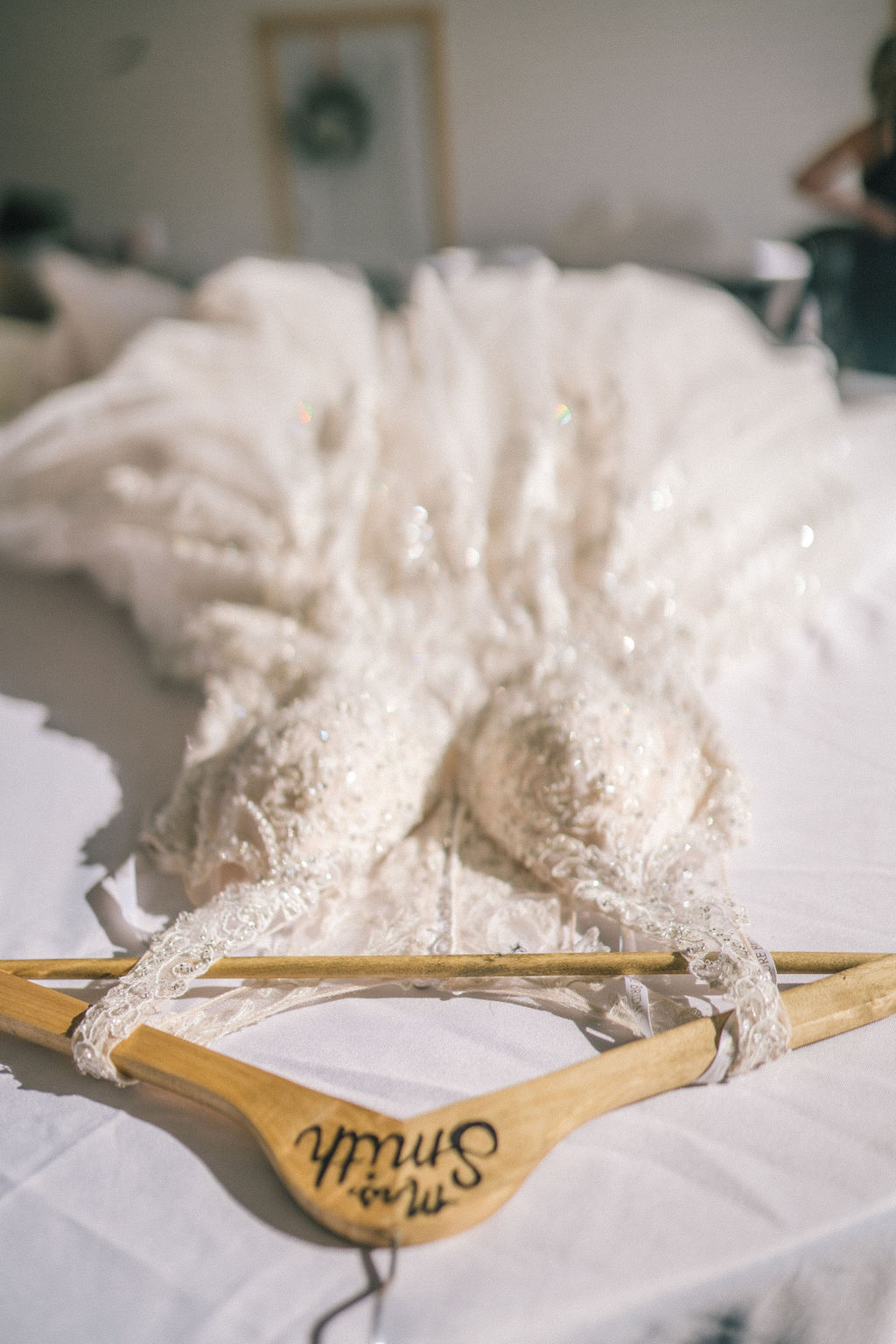 Top view of wedding dress laying flat on the hanger