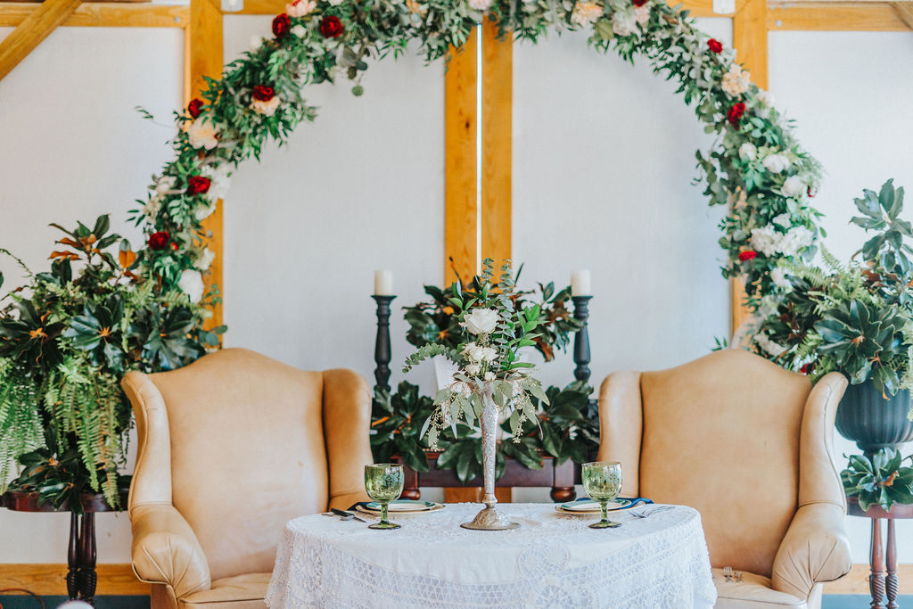 plan a Smoky Mountain wedding in 6 months with a stunning venue with florals and brown accent chairs at the bride and groom's table at the reception