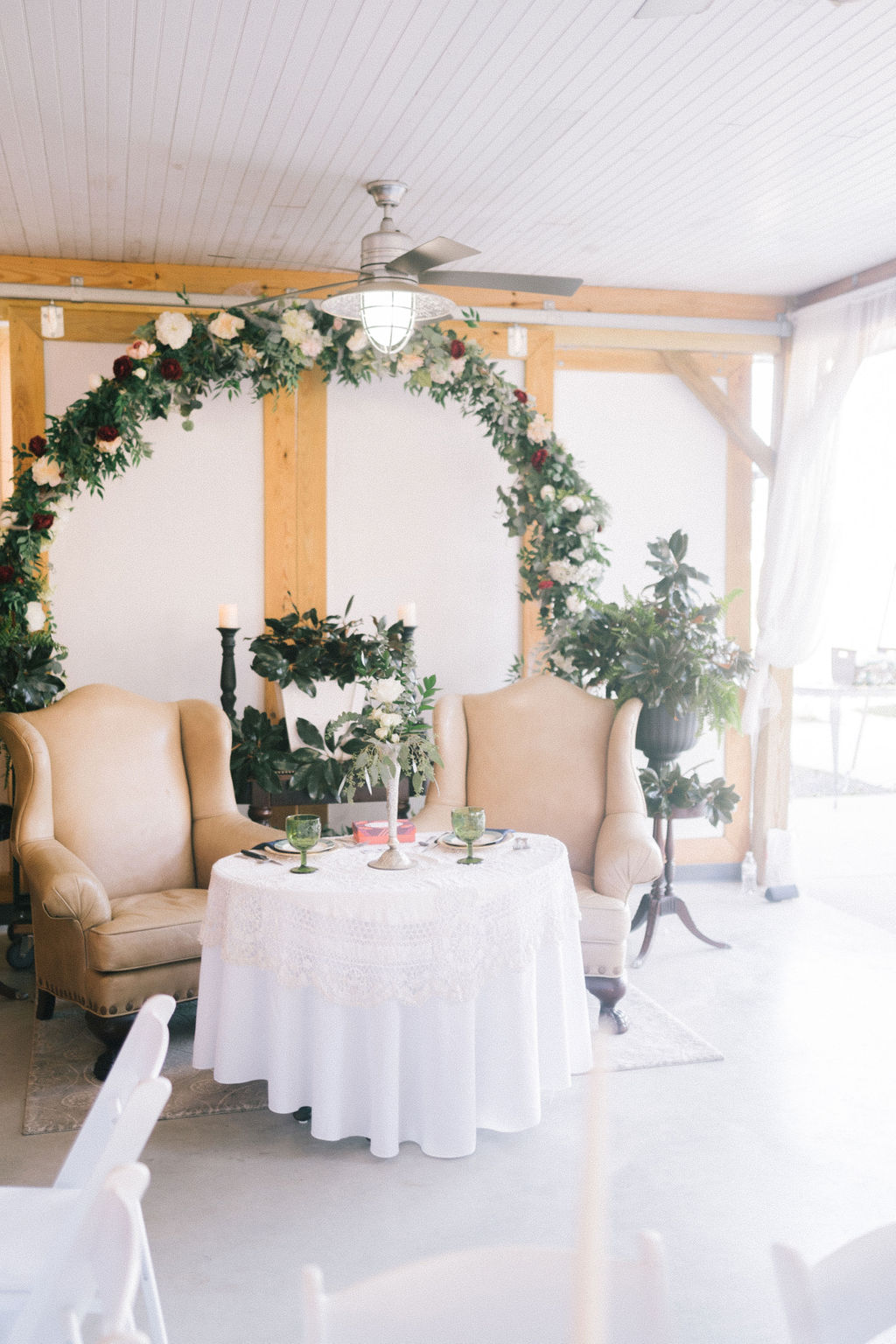 bride and groom sweethearts table with greenery and magnolia decor