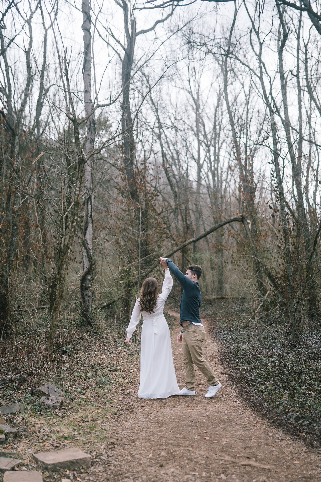 man and woman dancing in knoxville field during engagement sessions