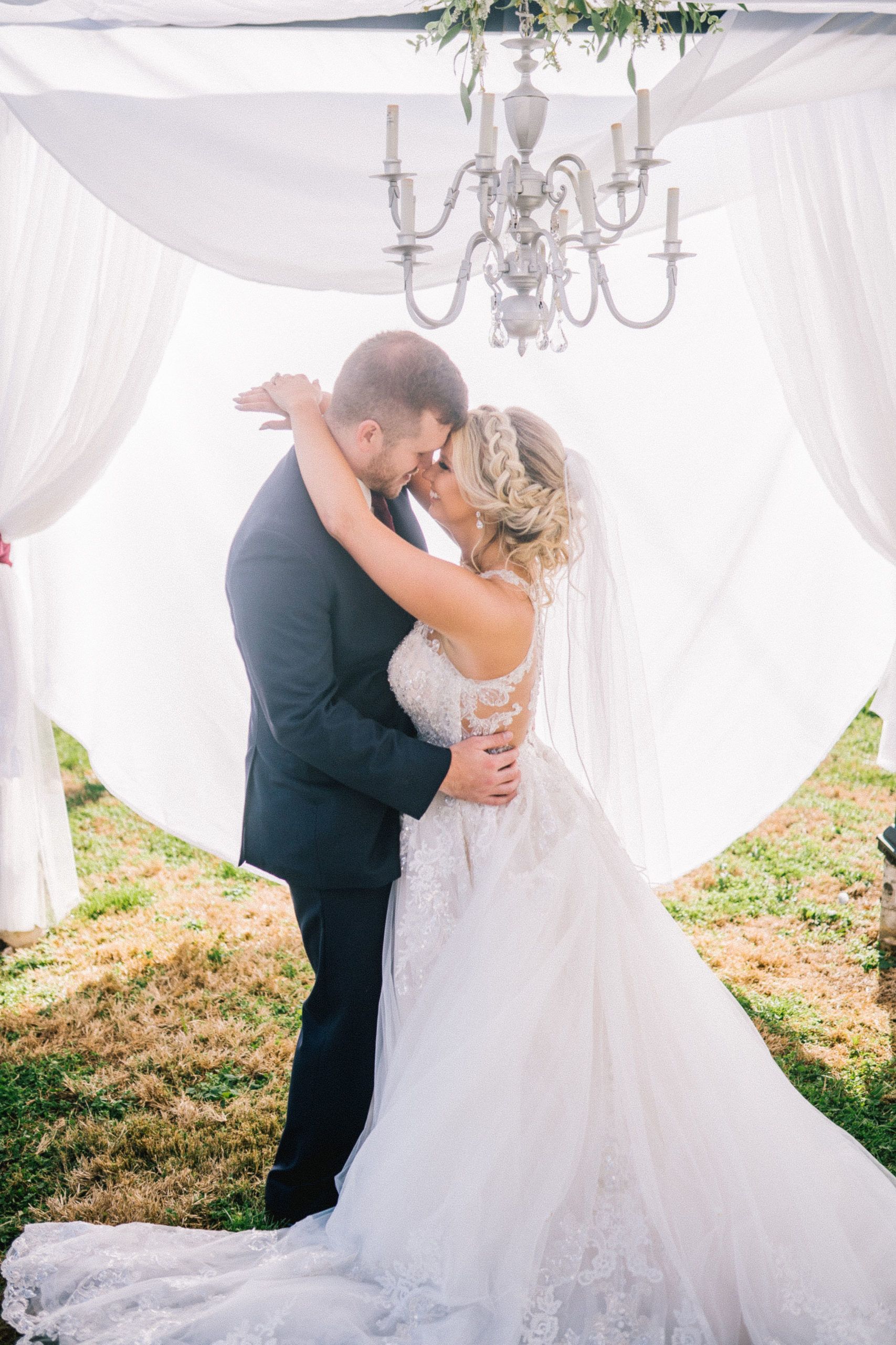 bride and groom kissing in a gazebo on their wedding day at their southern outdoor wedding