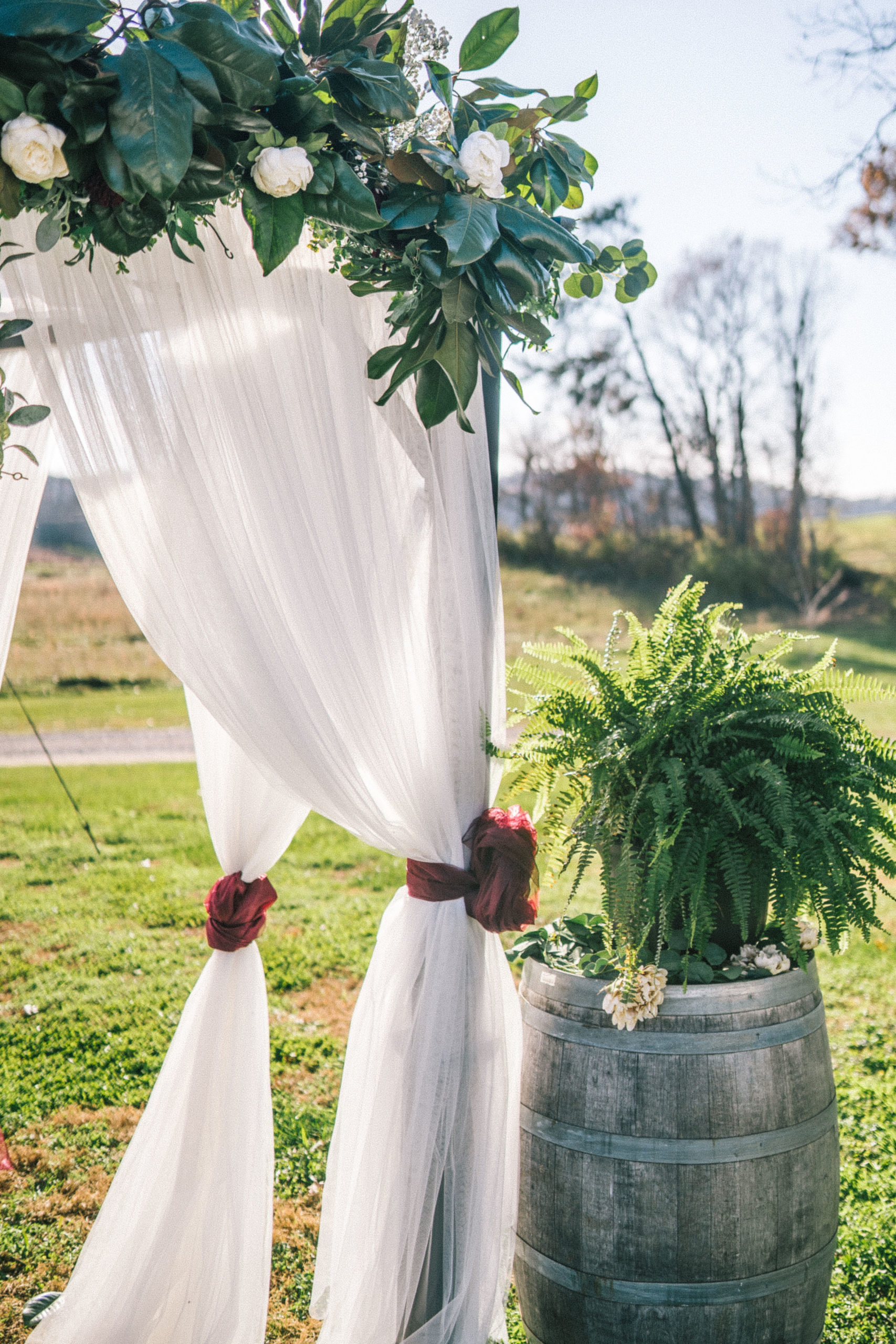 beautiful white draping for a wedding arch for a classy outdoor wedding decor