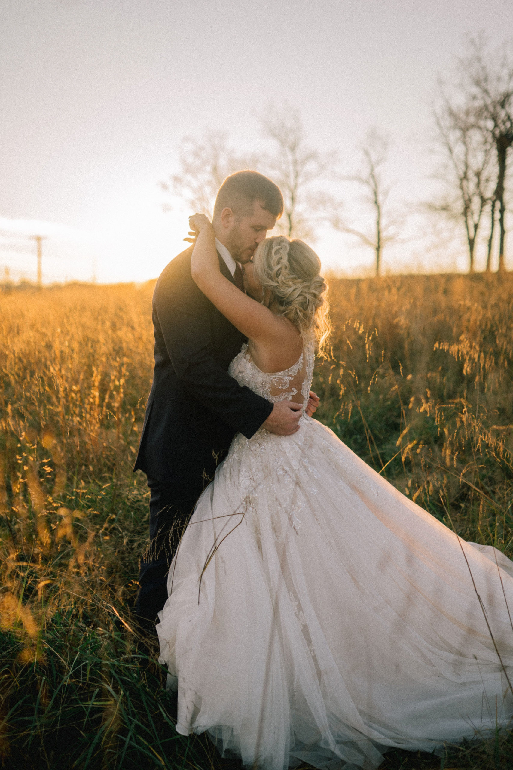 husband and wife on their wedding day in Tennessee kissing at sunset