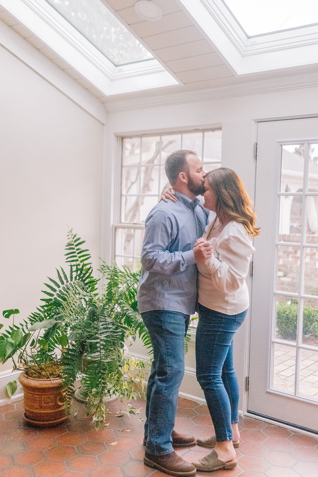 engagement session, man kissing womans forehead as they dance