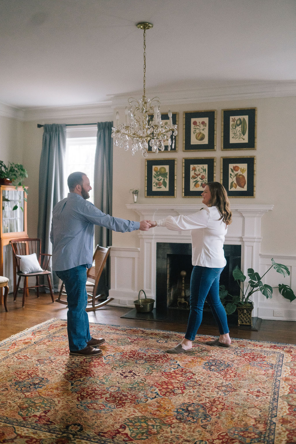 dancing in a living room for an in home engagement session in a beautiful southern home