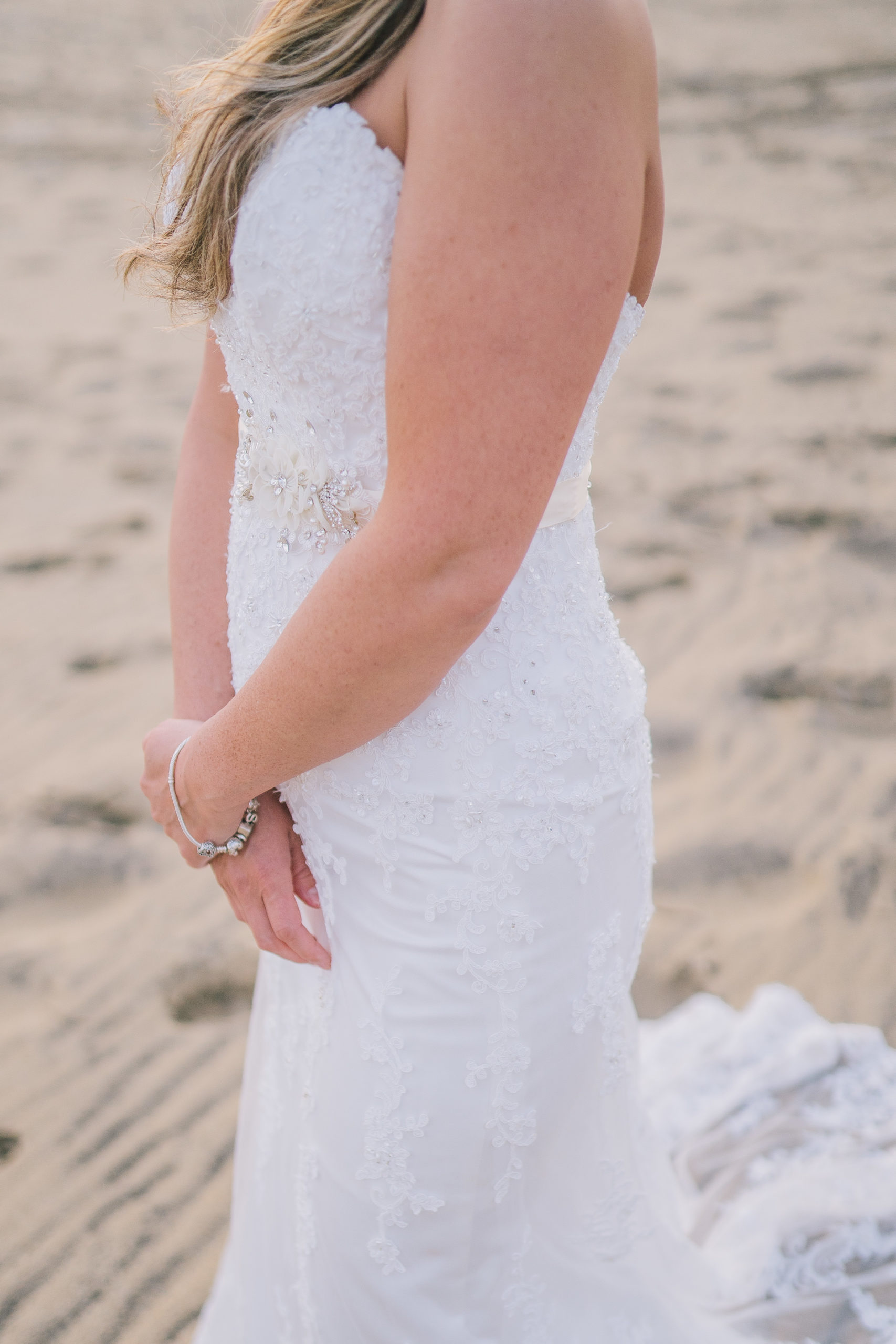 bridal session on the beach of outer banks, bride wearing a mermaid dress with lace detail