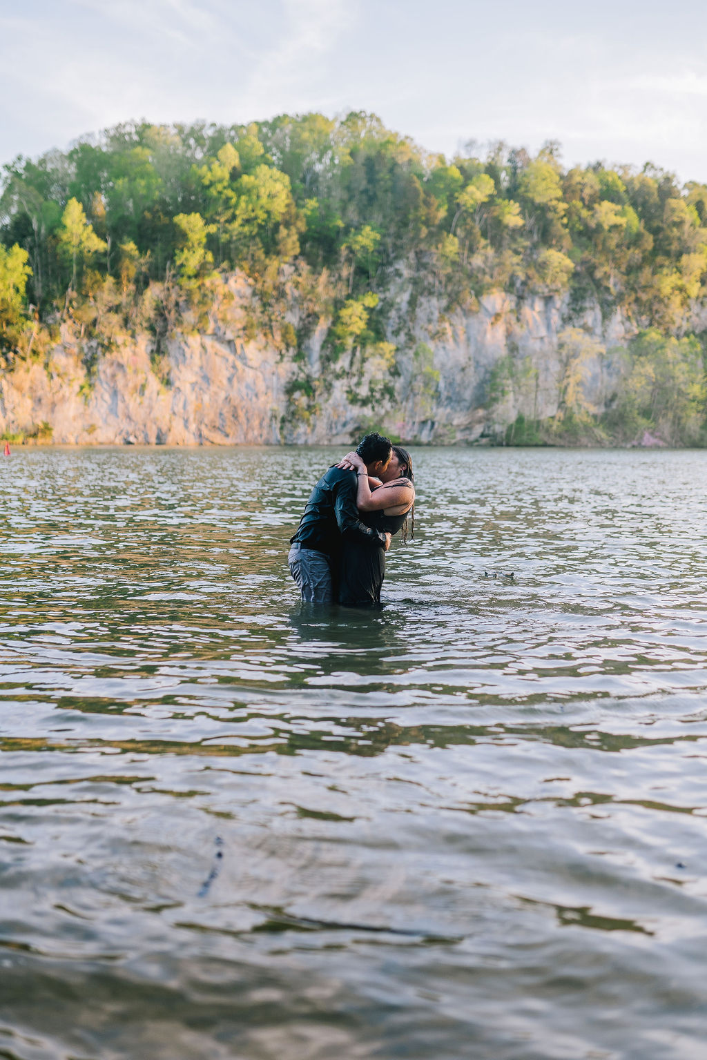 Meads Quarry engagement session in the water with man and woman kissing
