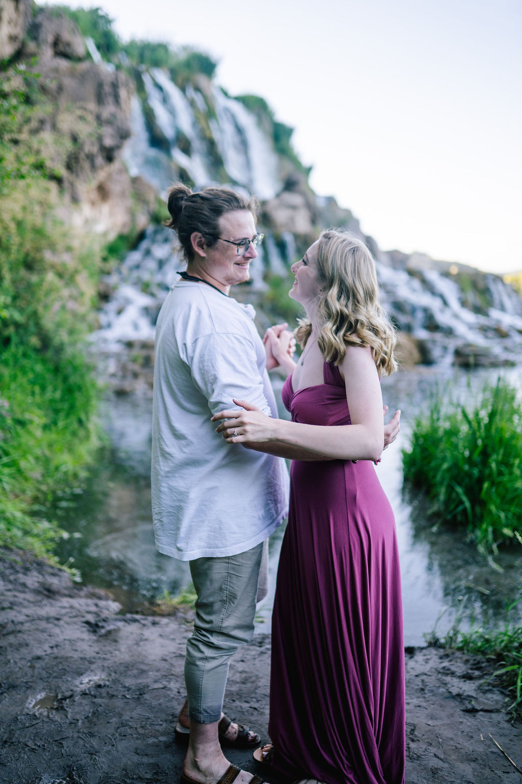 mand and fiance slow dance next to a pond for their adventure engagement session in Tennessee